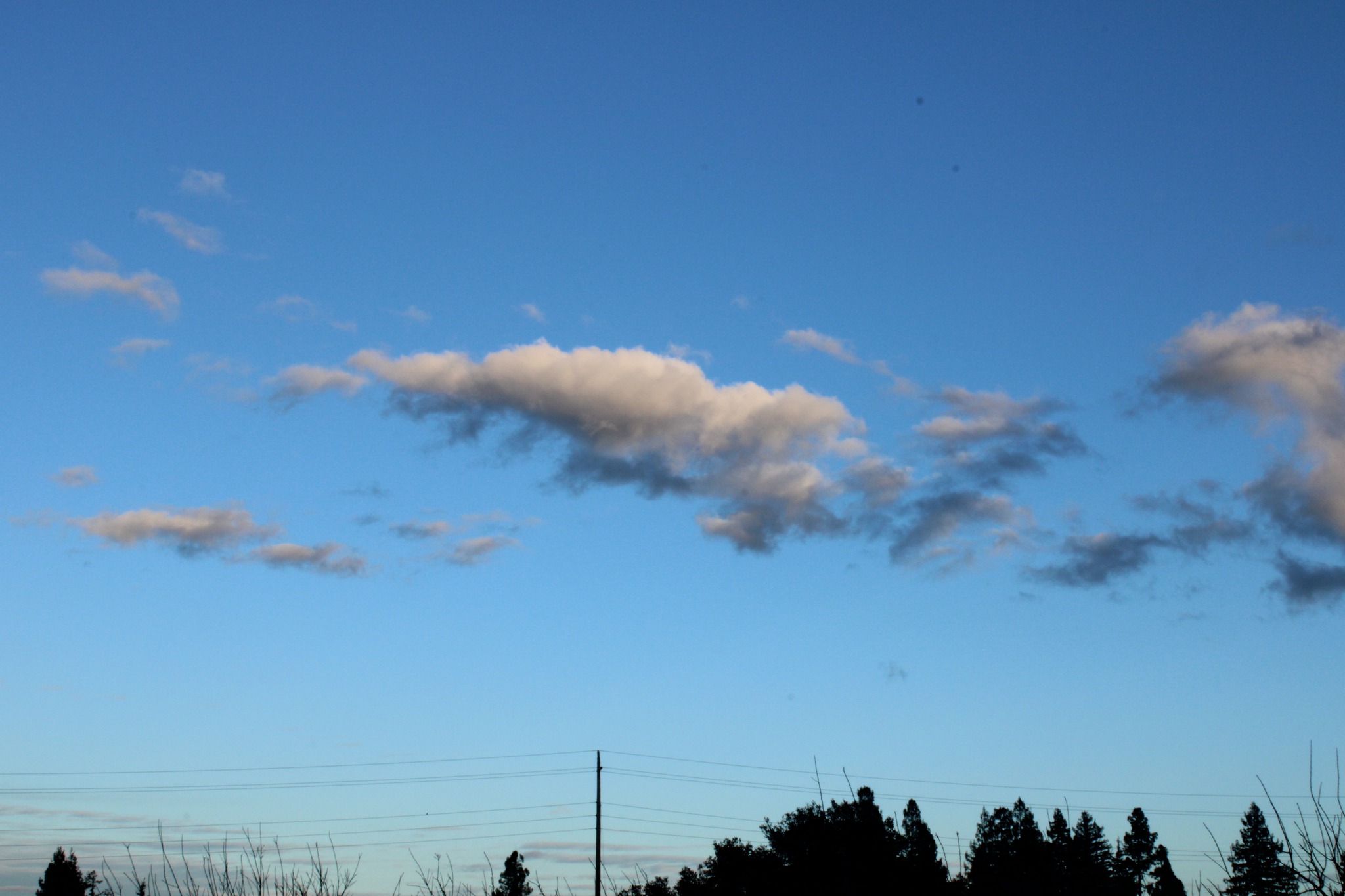 Wide blue sky with drifting clouds
