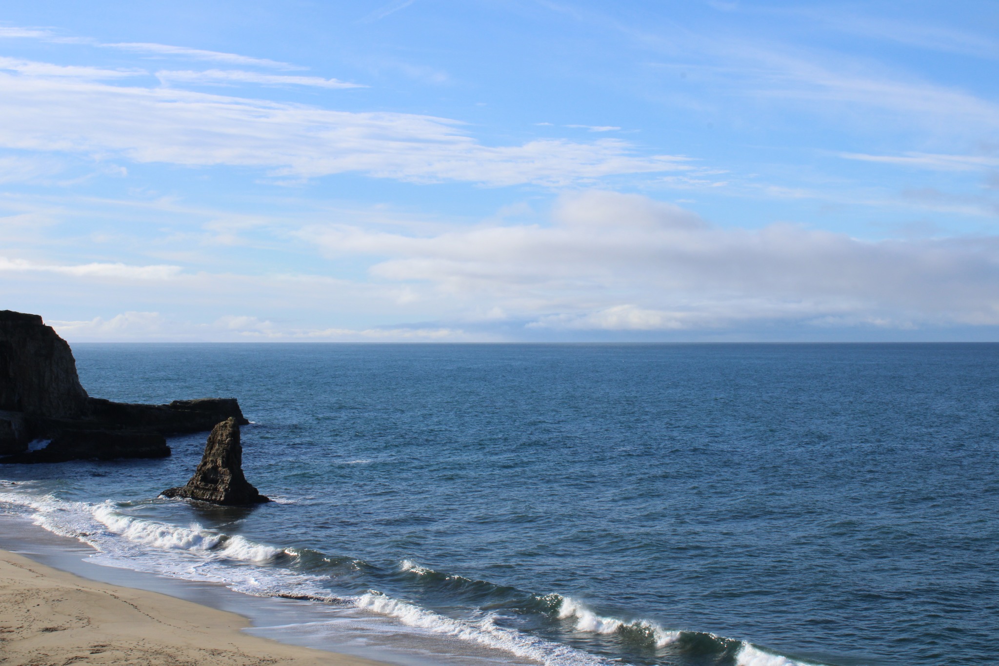 Coastal rock spire with waves, Pacific Ocean